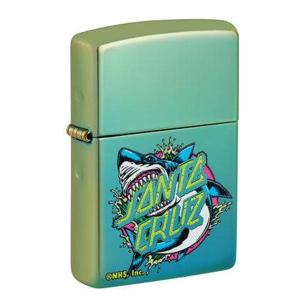 Front view of an iridescent teal Zippo lighter featuring a Santa Cruz Shark design. A fierce shark is jumping through water splashes with a lime green Santa Cruz logo overlaid on the graphic.