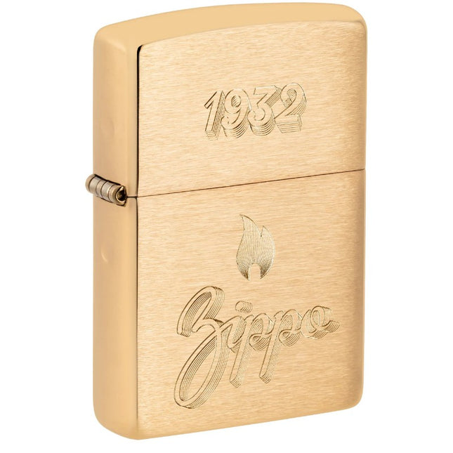 Front view of a Brushed Brass Zippo lighter with an engraved vintage design showing the year 1932 on the lid and the Zippo logo with a flame symbol on the body.'