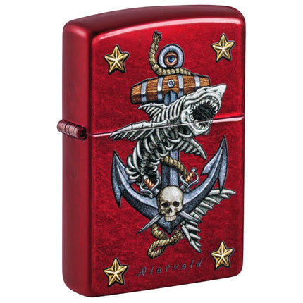 Front view of a glossy Candy Apple Red Zippo lighter featuring a nautical design by Rick Rietveld. The artwork depicts a large anchor with a rope, a skeleton shark, a pirate skull, and four gold stars in the corners.